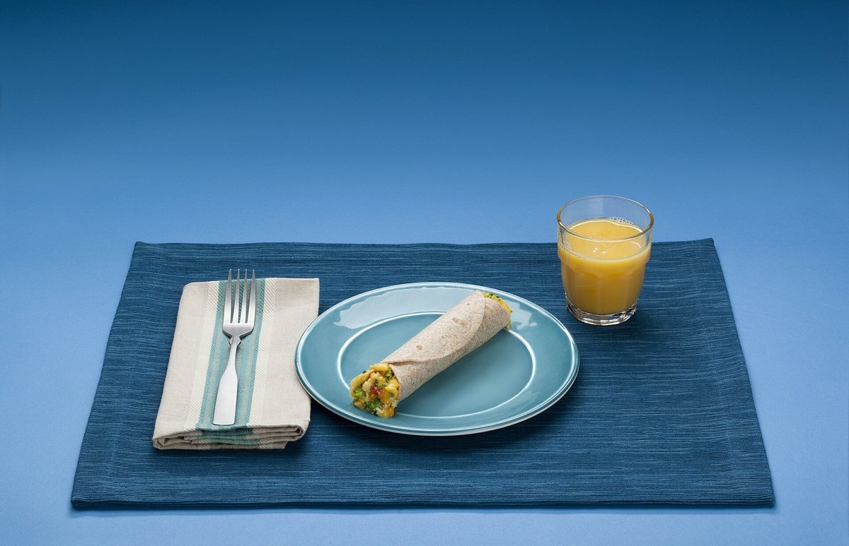 A balanced breakfast plate with eggs, fruit and vegetables - a protein-forward start to the day