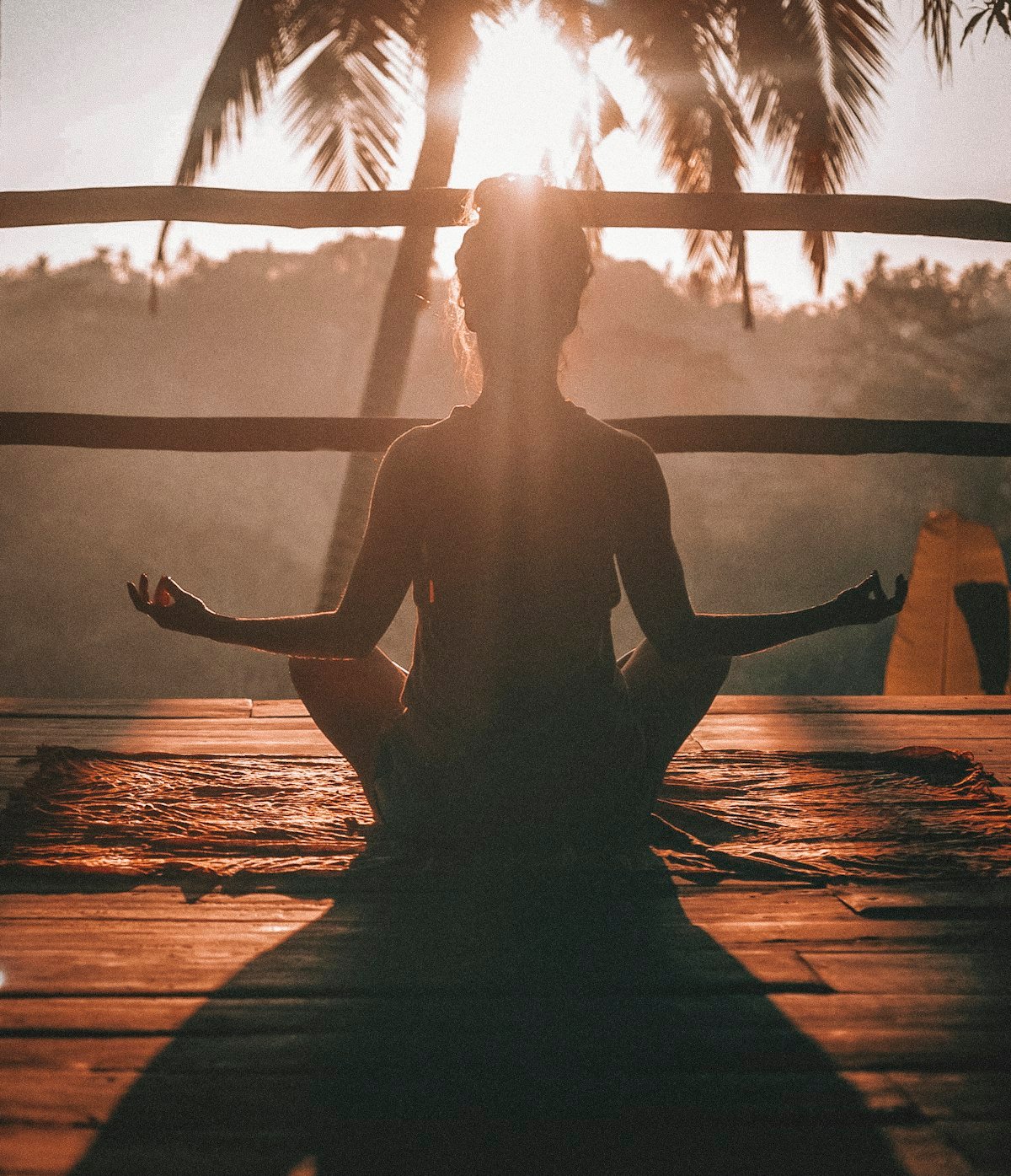 A person meditating peacefully in natural light