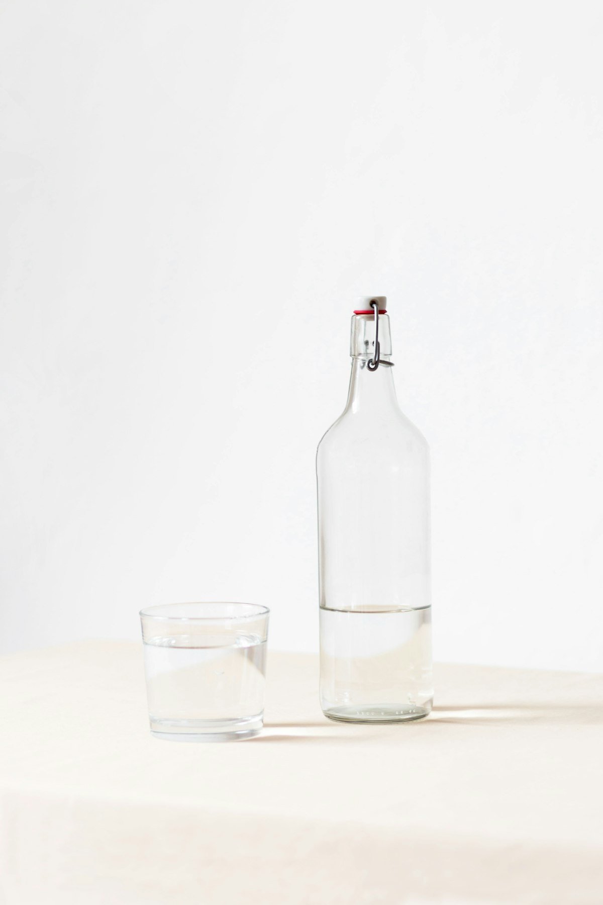 Glass of water on a table beside a healthy meal